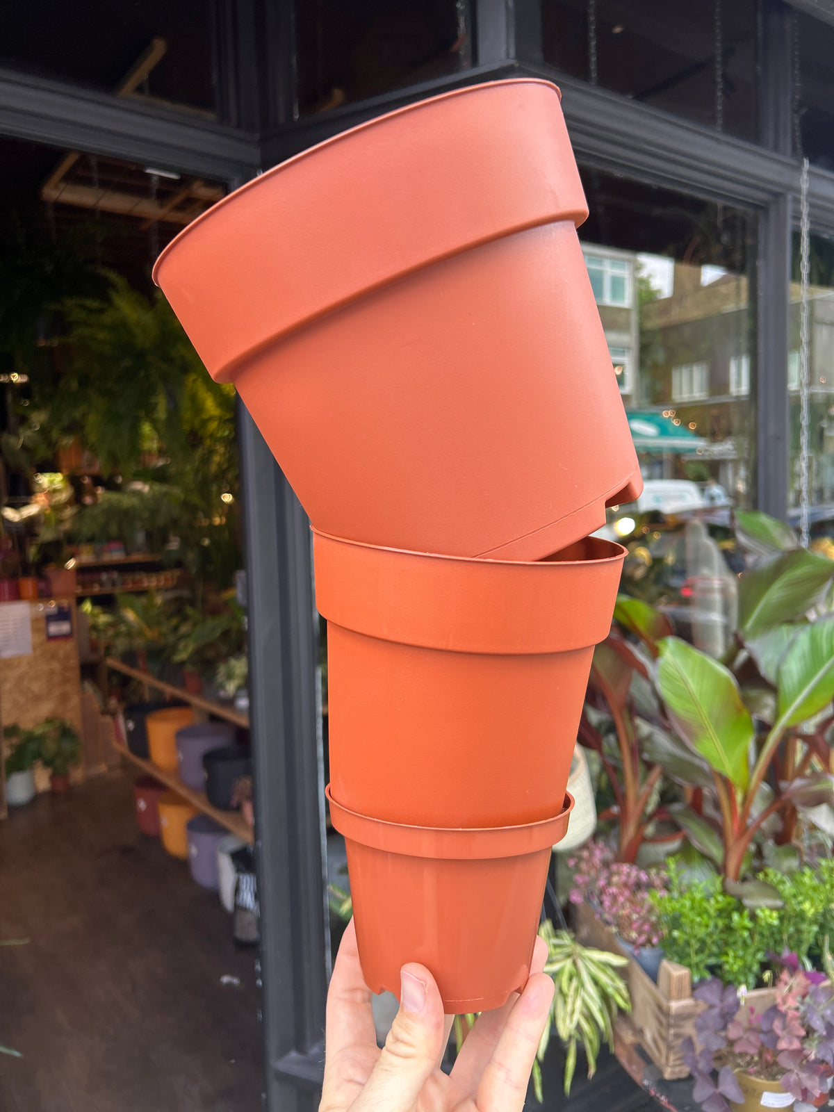 Terracotta plastic nursery pots in front of Urban Tropicana’s Plant Shop in Chiswick London