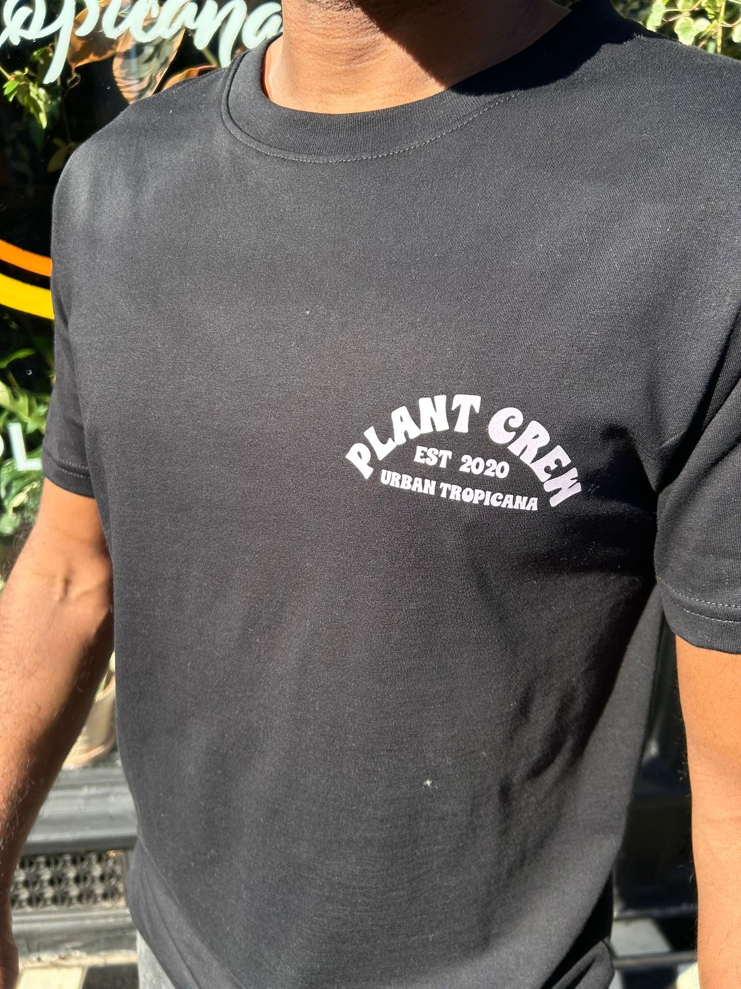 Person wearing a black t-shirt with &