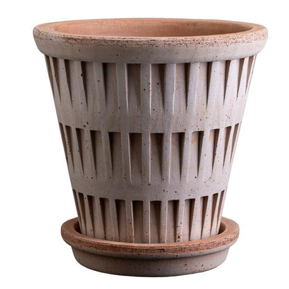 Terracotta planter with ribbed texture on a white background