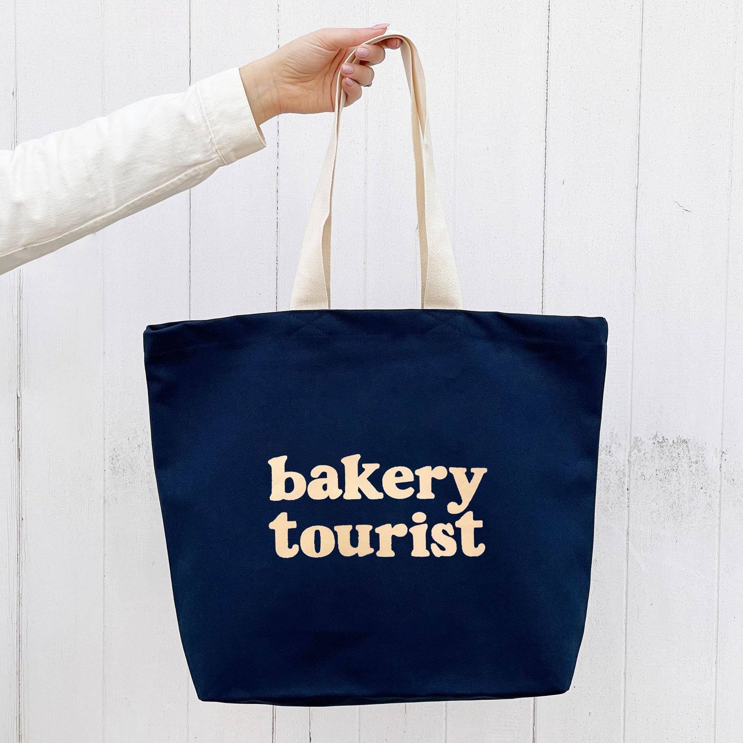 Midnight Blue Tote Bag with ‘Bakery Tourist’ Text on a White Background