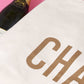 Natural Really Big Bag with ‘Champagne’ Text on a Pink Background