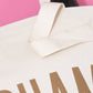 Natural Really Big Bag with ‘Champagne’ Text on a Pink Background