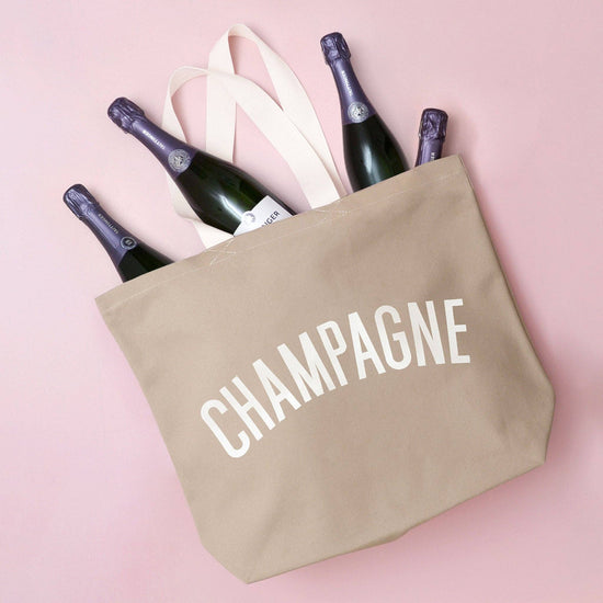 Stone Canvas Tote Bag with ‘Champagne’ text on a Pink Background
