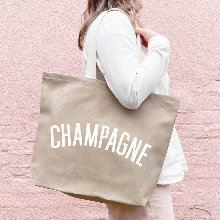 Stone Canvas Tote Bag with ‘Champagne’ text on a Pink Background