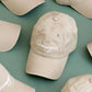 Cotton Baseball Cap with ‘Champagne?’ Text on a Green Background