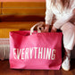 Bright Pink Really Big Bag with ‘Everything’ Text on a Neutral Background