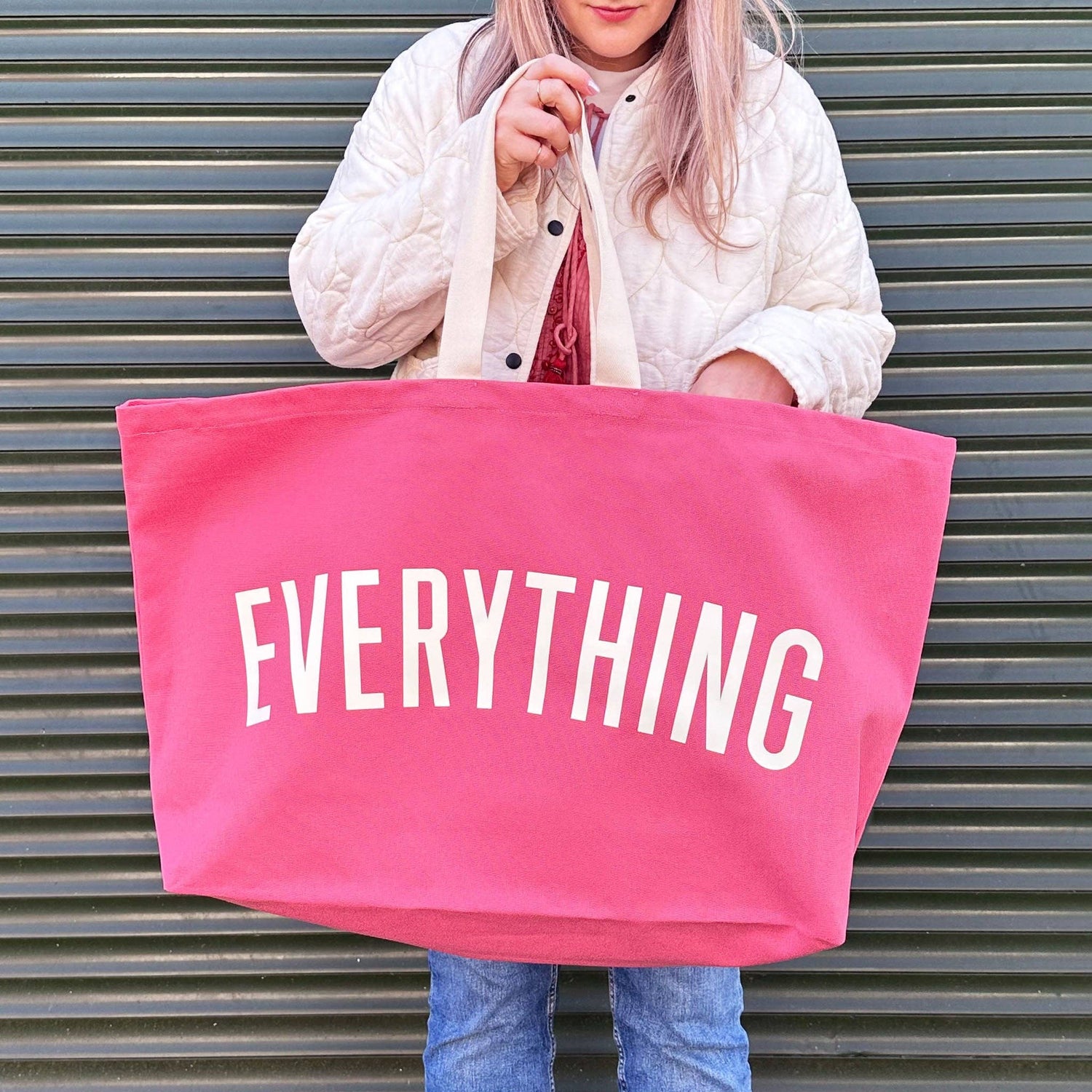 Bright Pink Really Big Bag with ‘Everything’ Text on a Green Background
