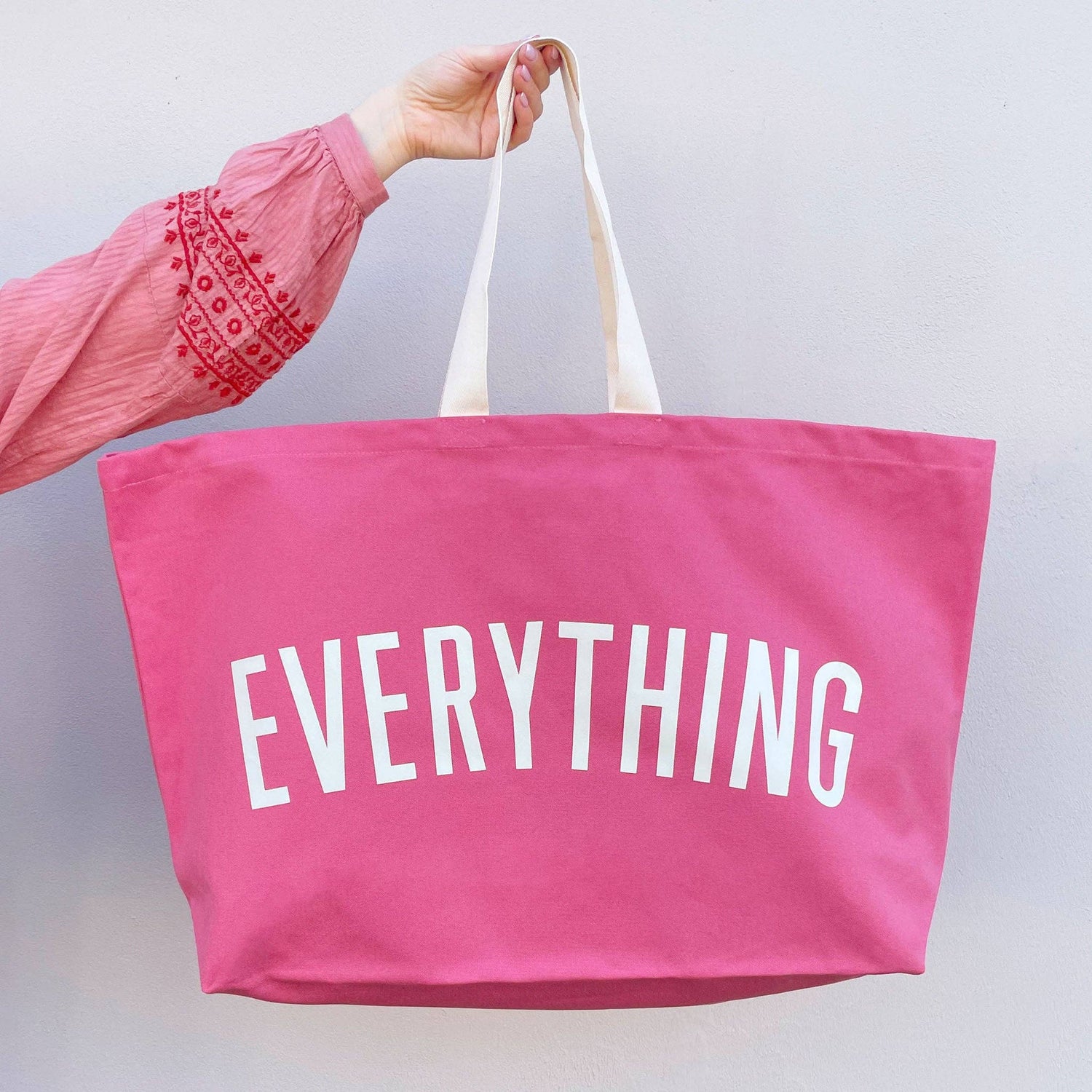 Bright Pink Really Big Bag with ‘Everything’ Text on a White Background