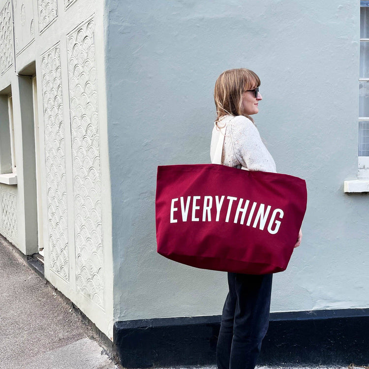 Burgundy Really Big Bag with ‘Everything’ Text on a Mixed Background