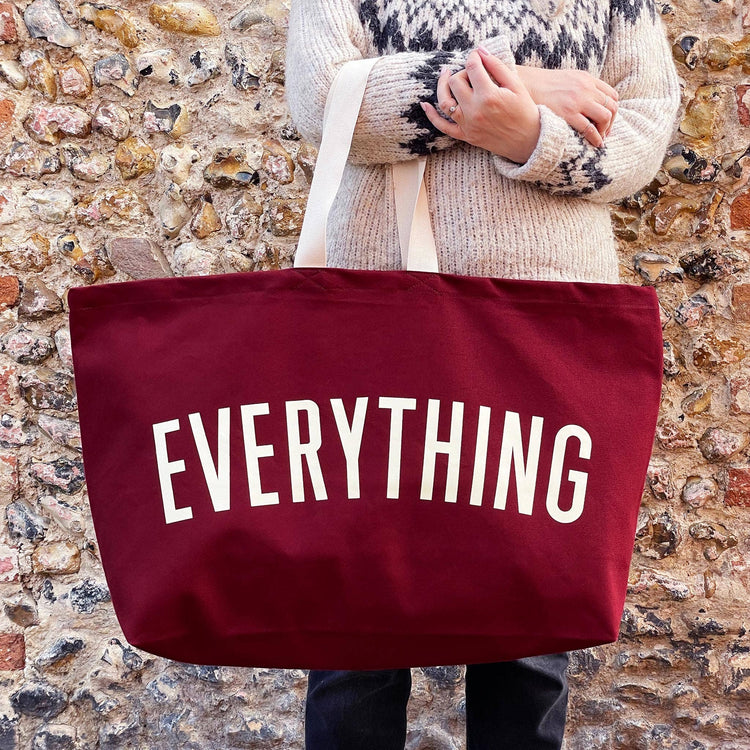 Burgundy Really Big Bag with ‘Everything’ Text on a Mixed Background