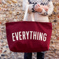 Burgundy Really Big Bag with ‘Everything’ Text on a Mixed Background