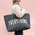 Grey Really Big Bag with ‘Everything’ Text on a Pink Background