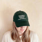 Person wearing a Cotton Baseball Cap with ‘Everything is Under Control’ text on a white  Background