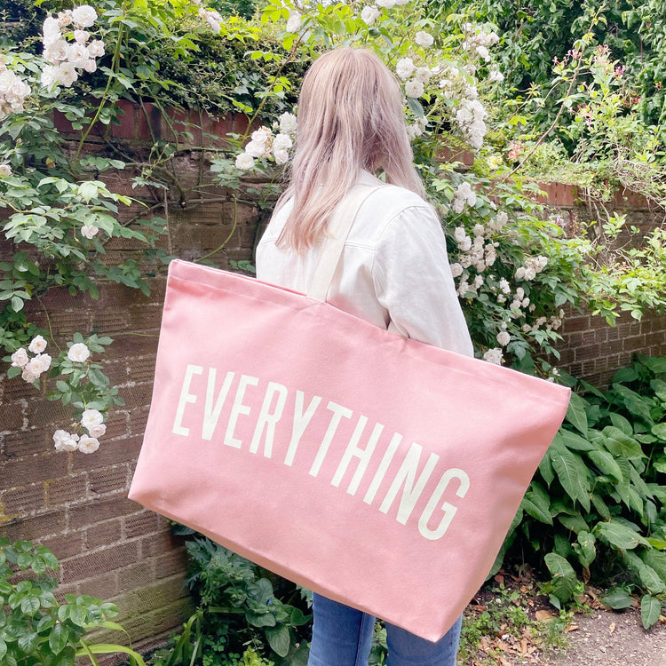 Pink Really Big Bag with ‘Everything’ Text on a Neutral Background