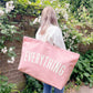 Pink Really Big Bag with ‘Everything’ Text on a Neutral Background