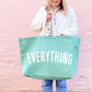 Person Carrying a Sea Glass Really Big Bag with ‘Everything’ Text on a Pink Background