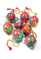 Colorful decorative balls with floral patterns and tassels on a white background