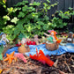Miniature garden scene with toy animals and plants
