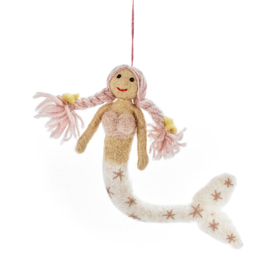 Knitted mermaid doll with pink hair and starfish tail on a white background