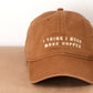 Cotton Baseball Cap with ‘I Think I Need More Coffee’ Text on a neutral Background