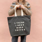 Person Carrying a Grey Tote Bag with ‘I Think I Need More Coffee’ Text on a Pink Background