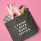 Grey Tote Bag with ‘I Think I Need More Coffee’ Text on a Pink Background