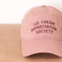 Dusty Rose Cotton Baseball Cap with ‘Ice Cream Appreciation Society’ Text on a Neutral Background