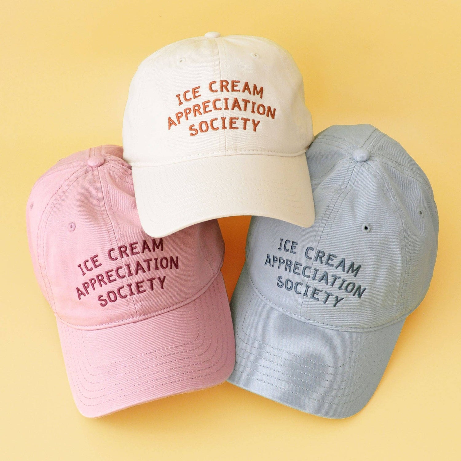 Dusty Rose Cotton Baseball Cap with ‘Ice Cream Appreciation Society’ Text on a Yellow Background