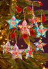 Colorful star-shaped Christmas ornaments on a tree with lights.
