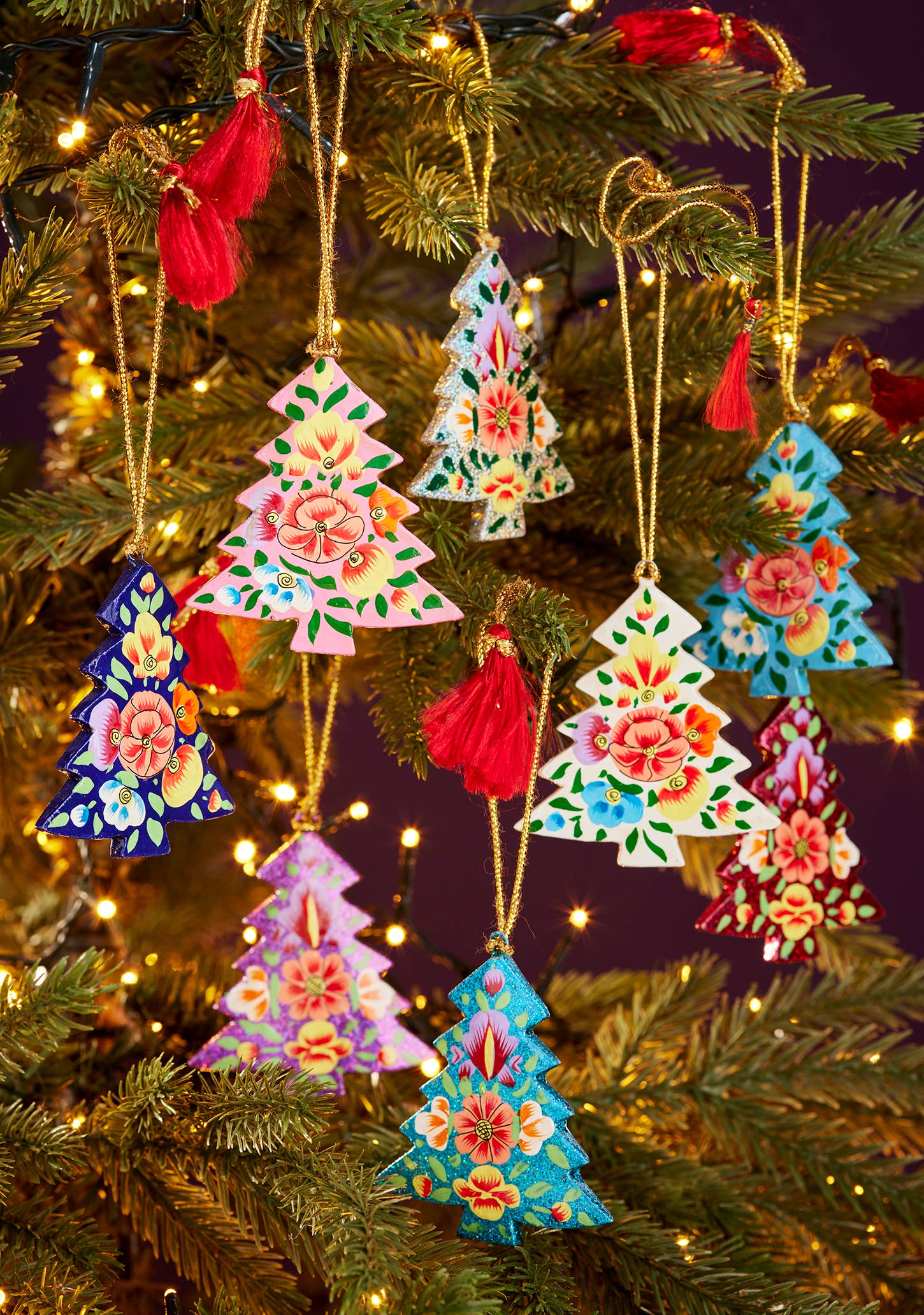 Decorative Christmas tree ornaments on a lit Christmas tree