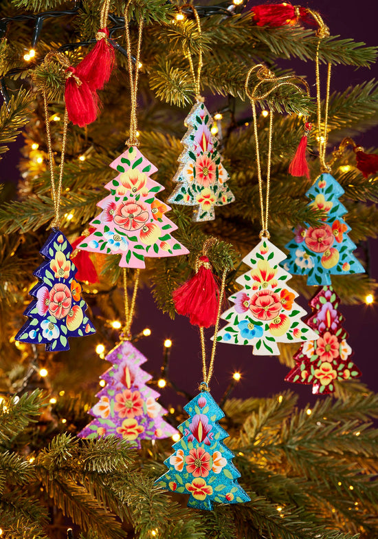 Decorative Christmas tree ornaments on a lit Christmas tree