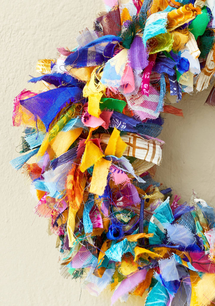 Colorful fabric wreath on a plain background