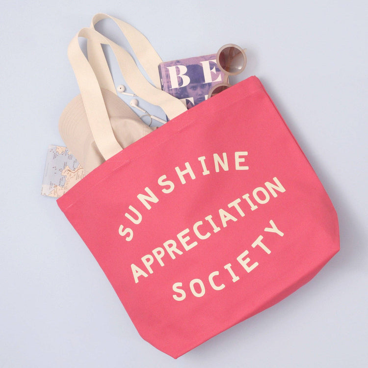 Bright Pink Canvas Tote Bag with ‘Sunshine Appreciation Society’ text on Blue Background