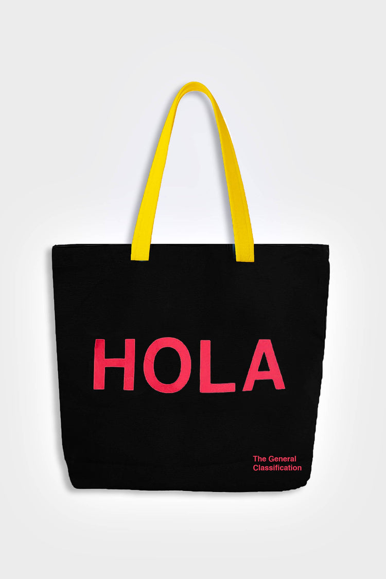 Black reusable canvas tote bag with yellow handles and bold red "Hola" and ‘Adiós’ graphic by The General Classification. Eco-friendly cotton shopping bag with modern minimalist design, ideal for everyday use, groceries, travel, and casual fashion.