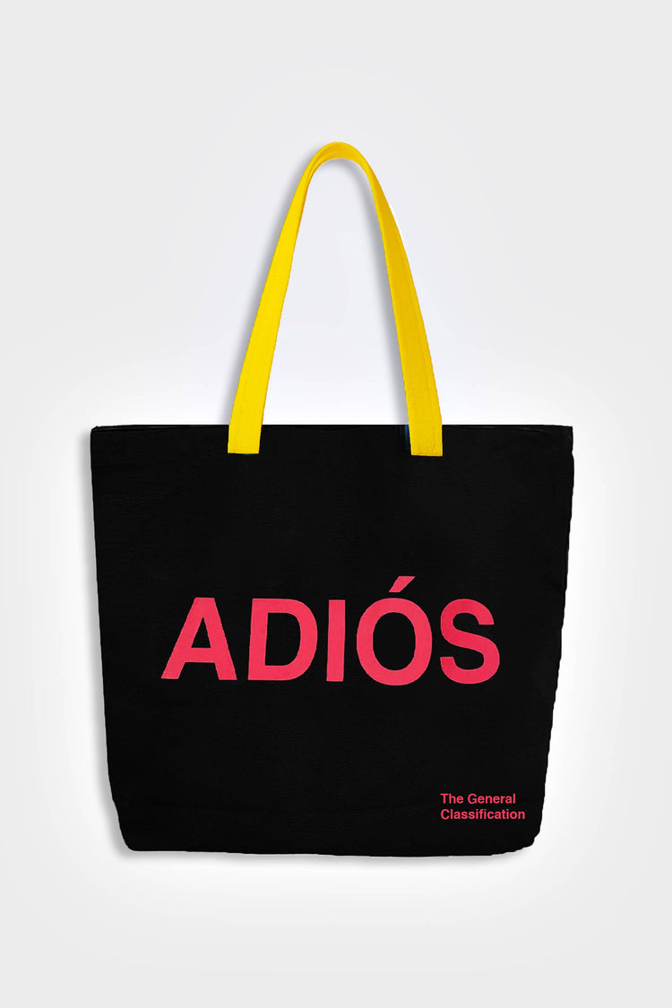 Black reusable canvas tote bag with yellow handles and bold red "Hola" and ‘Adiós’ graphic by The General Classification. Eco-friendly cotton shopping bag with modern minimalist design, ideal for everyday use, groceries, travel, and casual fashion.
