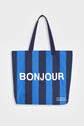 Blue and navy stripe reusable canvas tote bag with navy handles and bold white "Bonjour" and ‘Au Revoir’ graphic by The General Classification. Eco-friendly cotton shopping bag with modern minimalist design, ideal for everyday use, groceries, travel, and casual fashion.