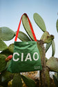 Green reusable canvas tote bag with red handles and bold white "Ciao" and ‘Arrivederci’ graphic by The General Classification. Eco-friendly cotton shopping bag with modern minimalist design, ideal for everyday use, groceries, travel, and casual fashion.