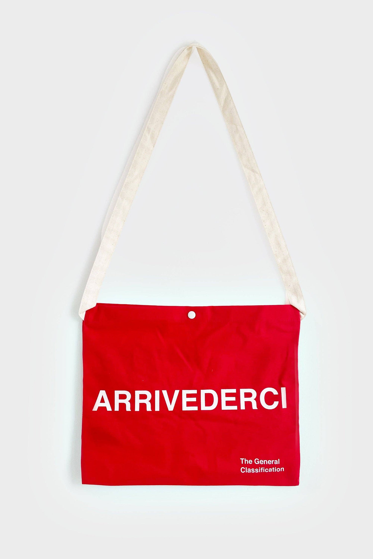 Red reusable canvas tote bag with white handles and bold white "Ciao" and ‘Arrivederci’ graphic by The General Classification. Eco-friendly cotton shopping bag with modern minimalist design, ideal for everyday use, groceries, travel, and casual fashion.