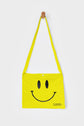 Yellow reusable canvas tote bag with yellow handles and bold black "Smiley Musette" graphic by The General Classification. Eco-friendly cotton shopping bag with modern minimalist design, ideal for everyday use, groceries, travel, and casual fashion.