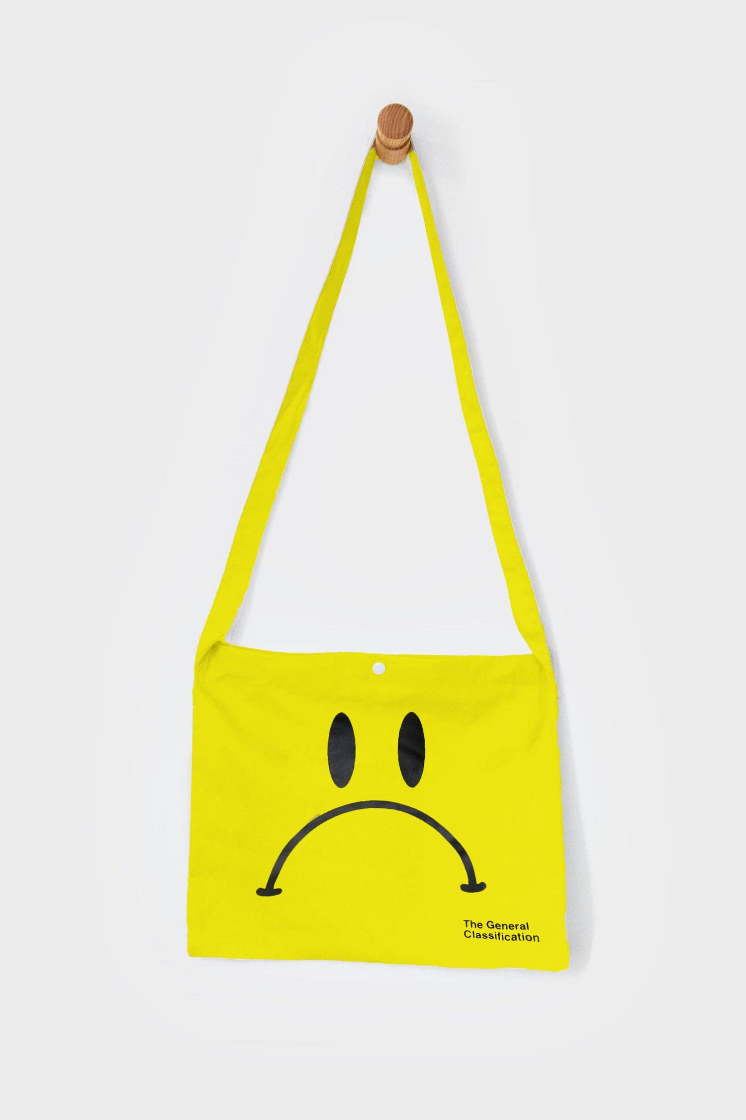 Yellow reusable canvas tote bag with yellow handles and bold black "Smiley Musette" graphic by The General Classification. Eco-friendly cotton shopping bag with modern minimalist design, ideal for everyday use, groceries, travel, and casual fashion.