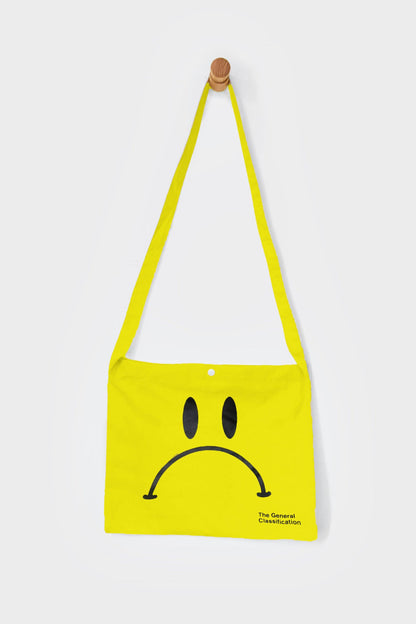 Yellow reusable canvas tote bag with yellow handles and bold black "Smiley Musette" graphic by The General Classification. Eco-friendly cotton shopping bag with modern minimalist design, ideal for everyday use, groceries, travel, and casual fashion.