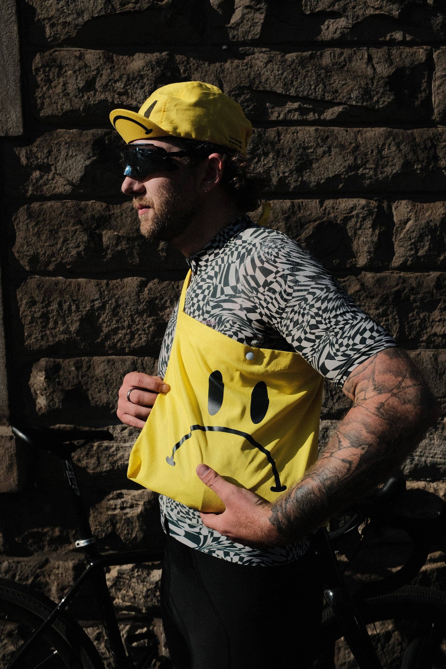 Yellow reusable canvas tote bag with yellow handles and bold black "Smiley Musette" graphic by The General Classification. Eco-friendly cotton shopping bag with modern minimalist design, ideal for everyday use, groceries, travel, and casual fashion.