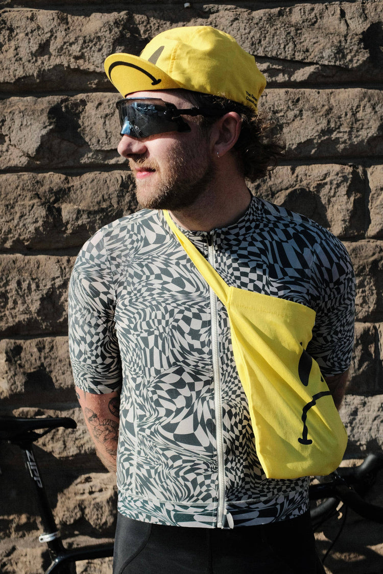 Yellow reusable canvas tote bag with yellow handles and bold black "Smiley Musette" graphic by The General Classification. Eco-friendly cotton shopping bag with modern minimalist design, ideal for everyday use, groceries, travel, and casual fashion.